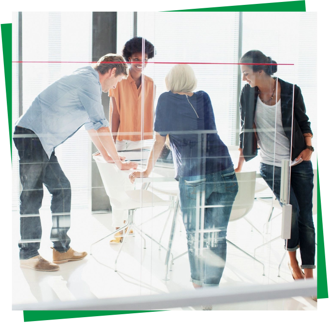 A group of people standing around a table.