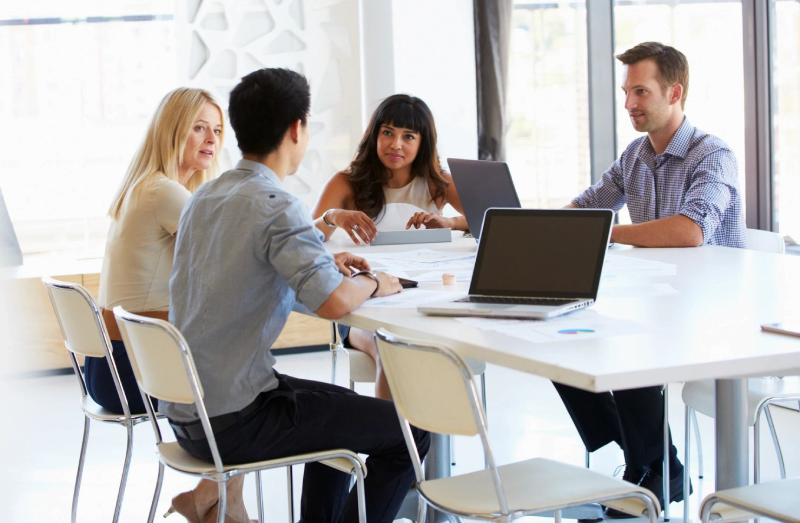 A group of people sitting around a table.