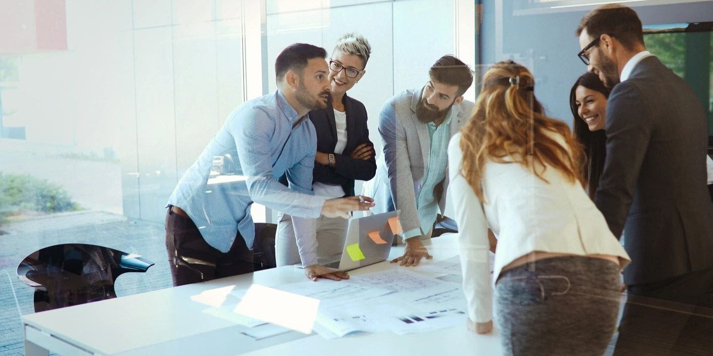 A group of people standing around a table.